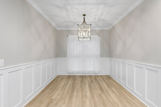 empty room featuring crown molding and light wood-type flooring