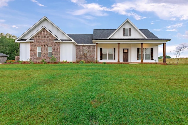 view of front of home with covered porch and a front lawn