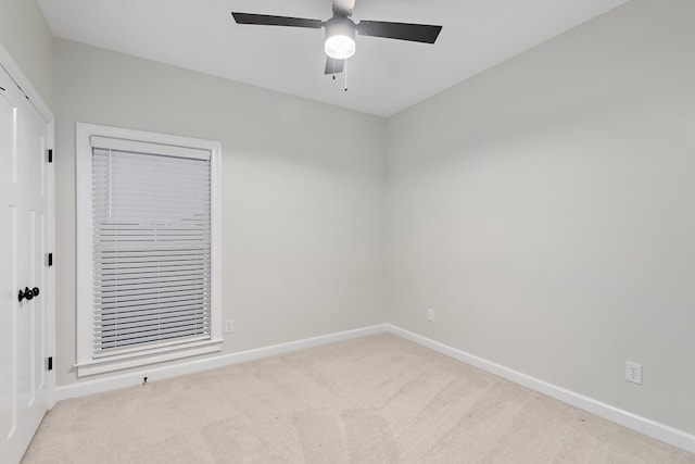 carpeted empty room with ceiling fan