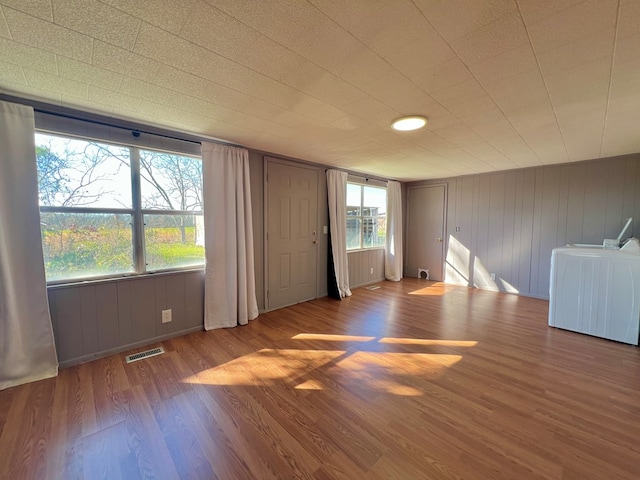 empty room with wood finished floors and visible vents