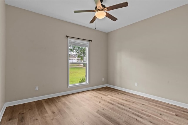 empty room featuring baseboards and wood finished floors