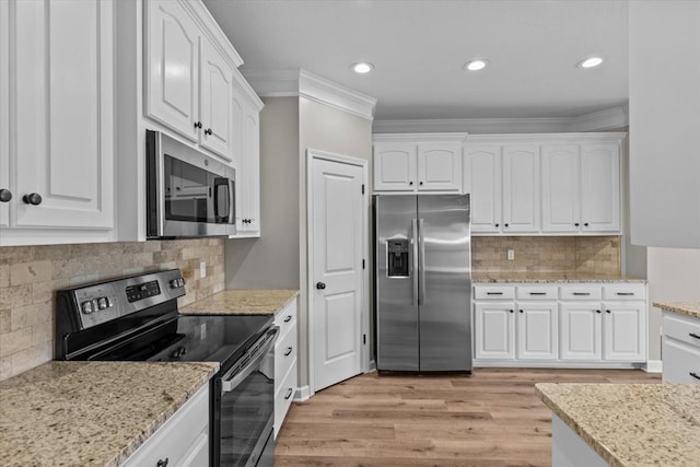 kitchen featuring crown molding, white cabinets, stainless steel appliances, and light wood-style flooring