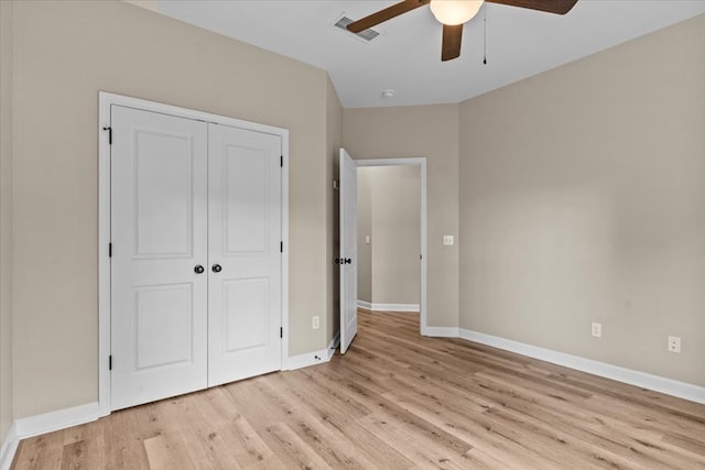unfurnished bedroom with visible vents, a closet, baseboards, ceiling fan, and light wood-type flooring