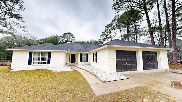 single story home featuring an attached garage, a front lawn, concrete driveway, and brick siding