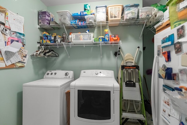 clothes washing area with laundry area and washer and clothes dryer