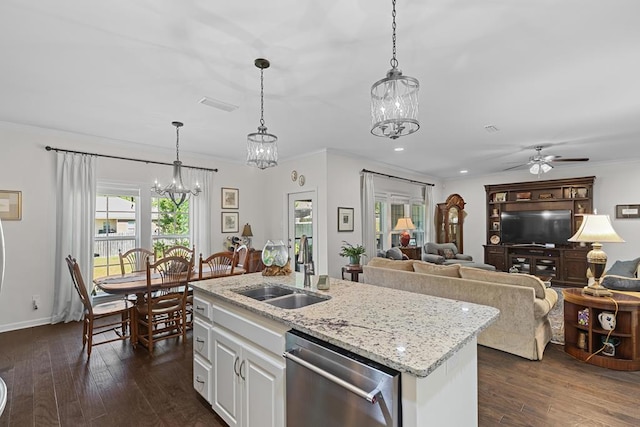 kitchen with hanging light fixtures, open floor plan, white cabinetry, a sink, and dishwasher