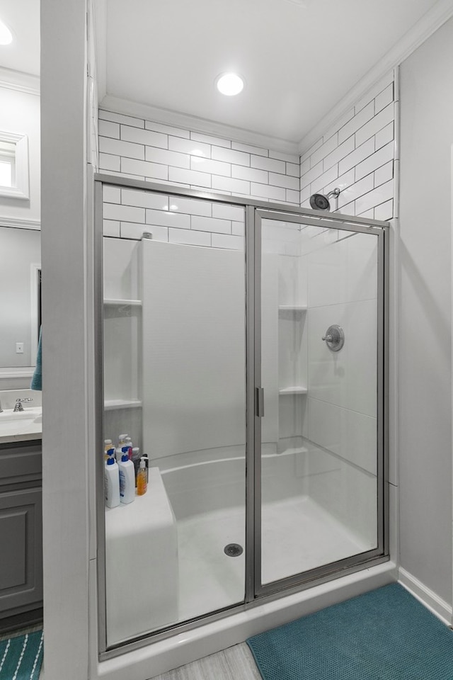 bathroom with a stall shower, vanity, and recessed lighting
