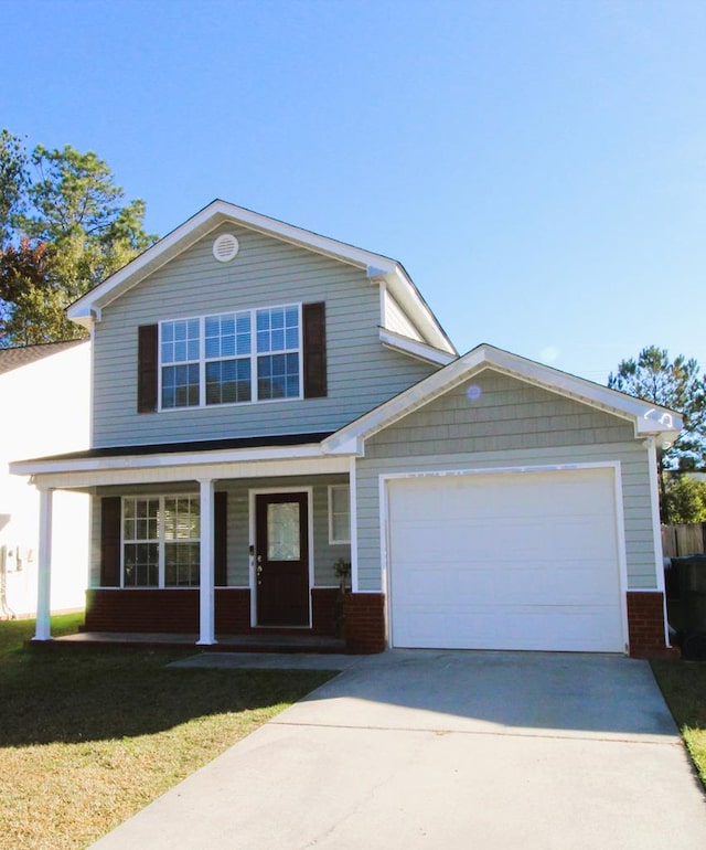 view of front of house with a front yard, a porch, and a garage