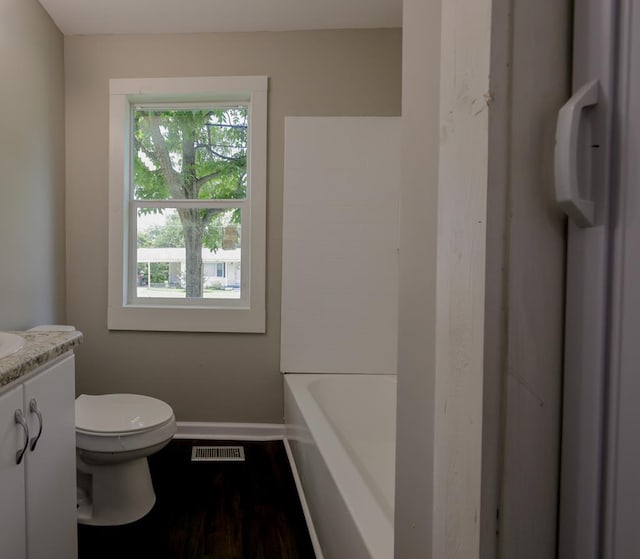 full bathroom featuring hardwood / wood-style flooring, vanity, separate shower and tub, and toilet