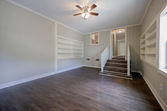 interior space with dark hardwood / wood-style floors, ceiling fan, built in features, and crown molding