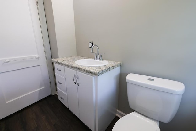 bathroom featuring hardwood / wood-style floors, vanity, and toilet