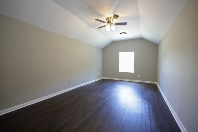 bonus room with ceiling fan, dark hardwood / wood-style flooring, and vaulted ceiling