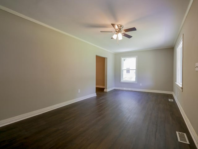 empty room featuring dark hardwood / wood-style floors, ceiling fan, and ornamental molding