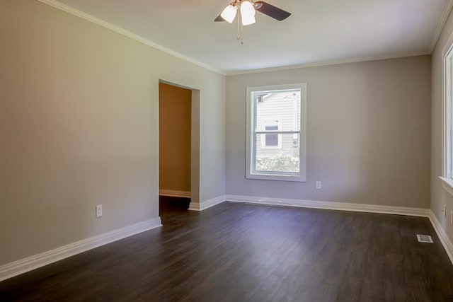 spare room featuring dark hardwood / wood-style floors, ceiling fan, and crown molding