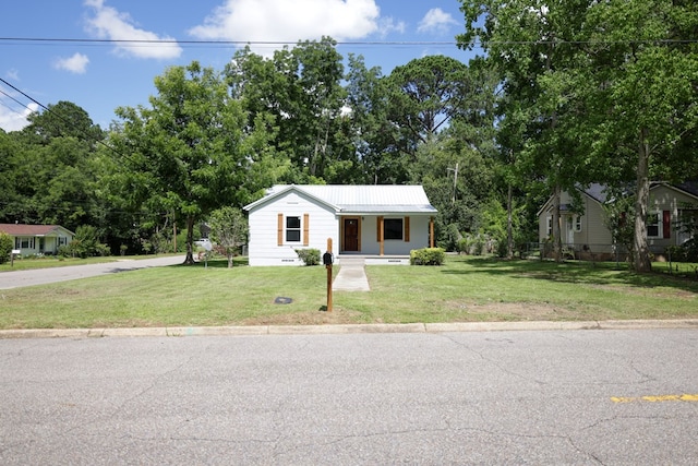 view of front of home with covered porch and a front lawn