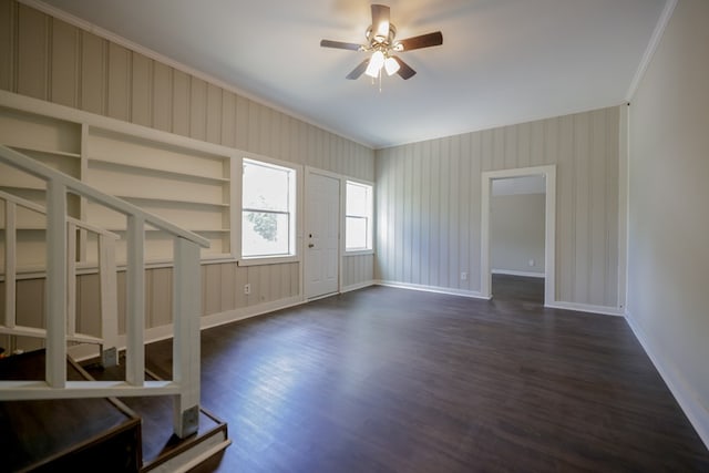 unfurnished living room with crown molding, dark hardwood / wood-style flooring, and ceiling fan