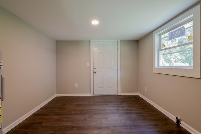 empty room with dark hardwood / wood-style floors