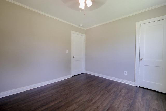 spare room with dark hardwood / wood-style flooring and crown molding