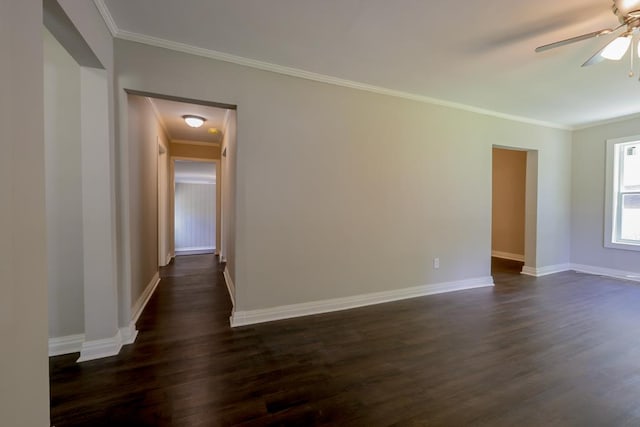 spare room featuring ornamental molding and dark wood-type flooring