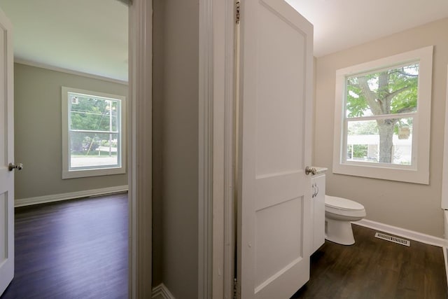 bathroom featuring hardwood / wood-style flooring and toilet