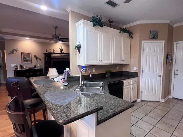 kitchen featuring black dishwasher, visible vents, white cabinets, a sink, and ceiling fan