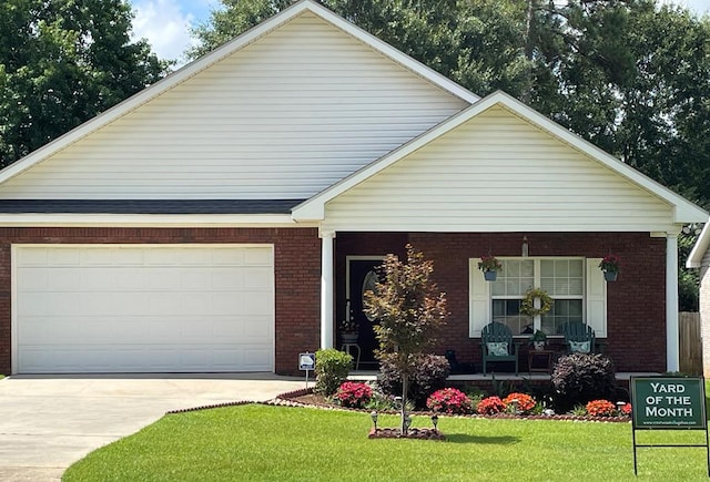 view of front facade featuring driveway, a porch, a front lawn, and brick siding