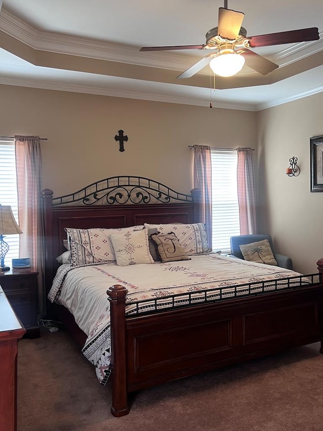 bedroom with ornamental molding, dark carpet, and ceiling fan