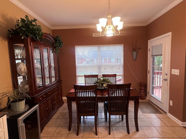 dining room with a chandelier, ornamental molding, light tile patterned flooring, and baseboards