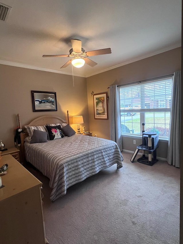 carpeted bedroom with a ceiling fan, visible vents, crown molding, and baseboards