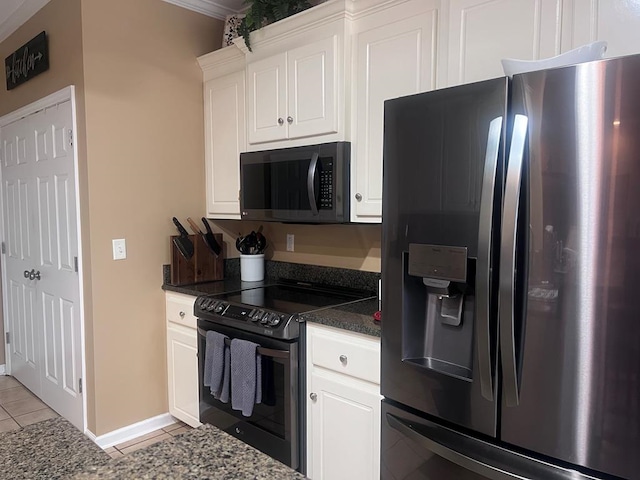 kitchen with white cabinets, dark stone countertops, black range with electric stovetop, refrigerator with ice dispenser, and light tile patterned flooring