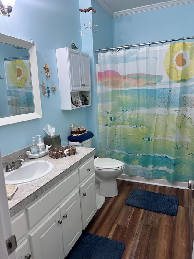 full bath with vanity, ornamental molding, wood finished floors, and toilet