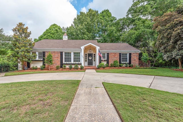 702 W Lee St, Enterprise, AL 36330 - ranch-style home featuring brick siding, a front yard, and curved driveway