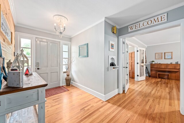 702 W Lee St, Enterprise, AL 36330 - entryway with ornamental molding, a chandelier, and light wood finished floors