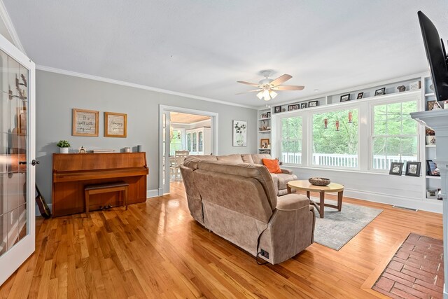 702 W Lee St, Enterprise, AL 36330 - living area featuring a ceiling fan, crown molding, and wood finished floors