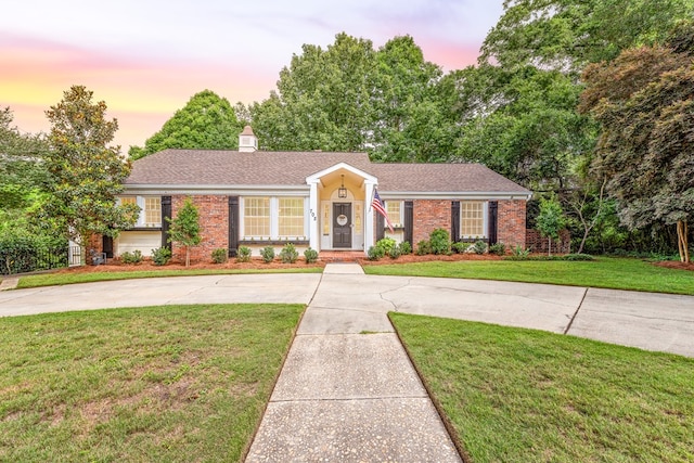 702 W Lee St, Enterprise, AL 36330 - single story home featuring brick siding, a yard, curved driveway, and roof with shingles