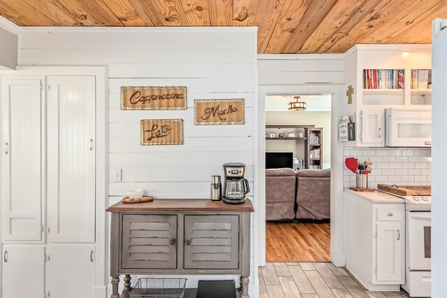 702 W Lee St, Enterprise, AL 36330 - kitchen with white appliances, wood ceiling, backsplash, light wood-style flooring, and white cabinetry