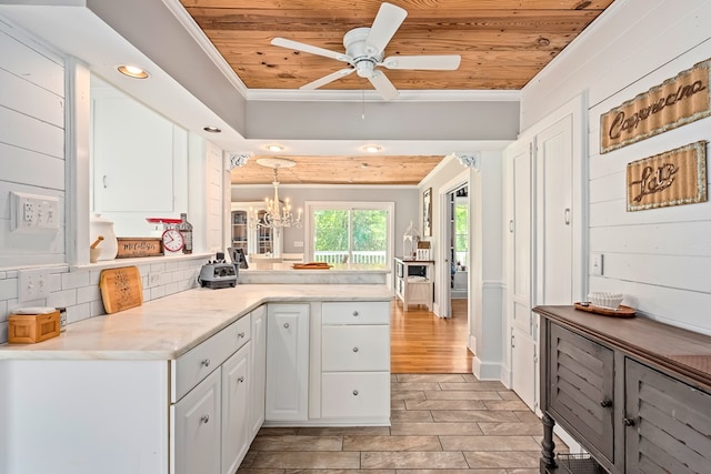 702 W Lee St, Enterprise, AL 36330 - kitchen with wood ceiling, ornamental molding, white cabinets, ceiling fan, and a peninsula