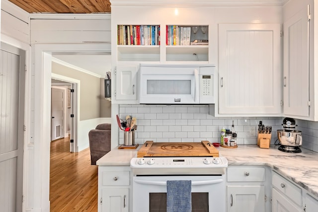 702 W Lee St, Enterprise, AL 36330 - kitchen with white appliances, ornamental molding, wood finished floors, white cabinetry, and backsplash