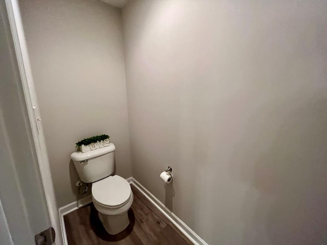 bathroom featuring hardwood / wood-style floors and toilet