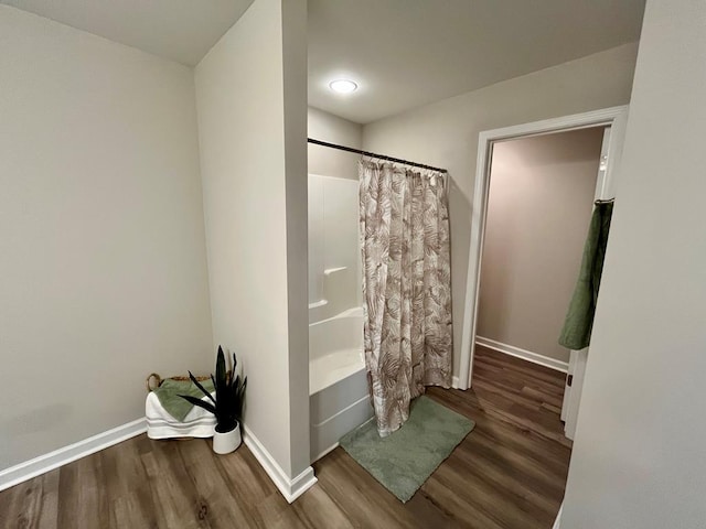 bathroom featuring hardwood / wood-style floors and shower / bath combo