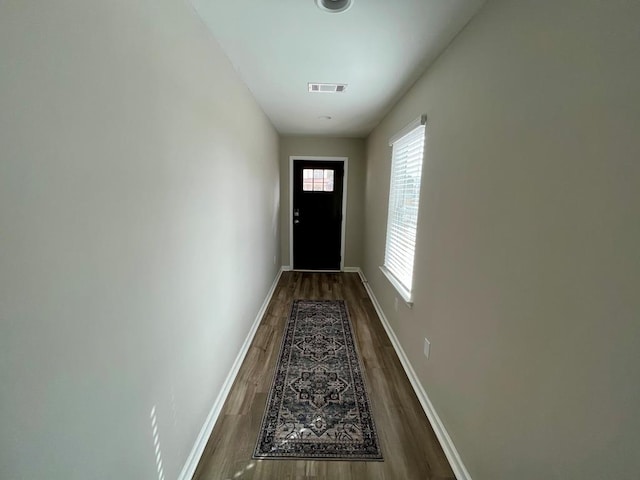 doorway with dark wood-type flooring