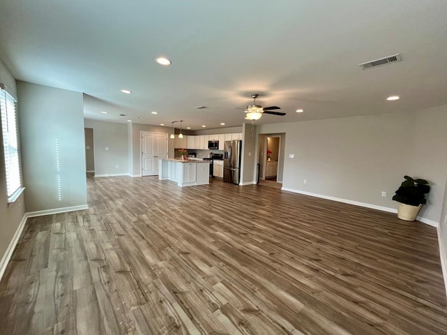 unfurnished living room with ceiling fan and light hardwood / wood-style floors