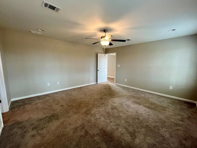 carpeted spare room featuring ceiling fan