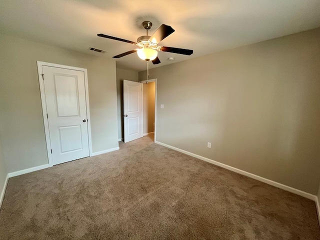 unfurnished bedroom with carpet floors and ceiling fan