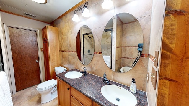 1622 W Main St, Daleville, AL 36322 - bathroom featuring ornamental molding, tile walls, toilet, and double vanity