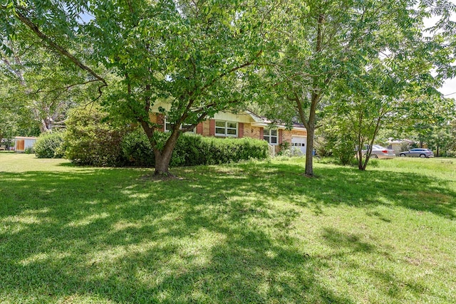803 Dogwood Trl, Dothan, AL 36301 - view of green lawn with a garage