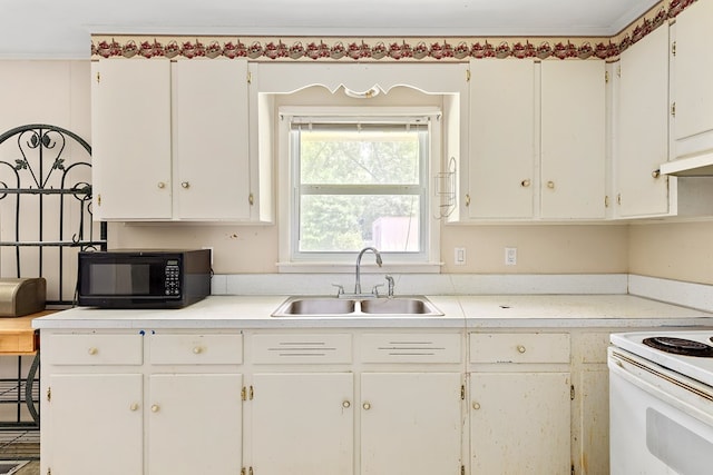 803 Dogwood Trl, Dothan, AL 36301 - kitchen with black microwave, electric range, white cabinets, and light countertops