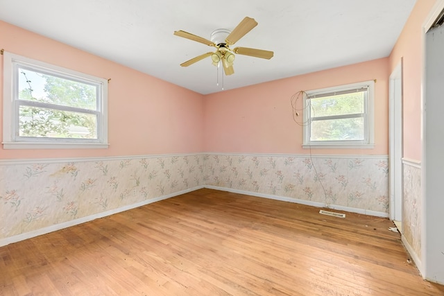 803 Dogwood Trl, Dothan, AL 36301 - unfurnished room featuring healthy amount of natural light, light wood finished floors, ceiling fan, and wallpapered walls