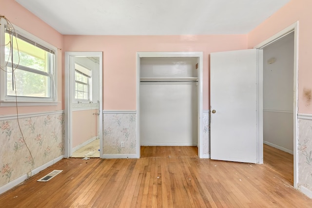 803 Dogwood Trl, Dothan, AL 36301 - unfurnished bedroom with a wainscoted wall, hardwood / wood-style floors, and a closet