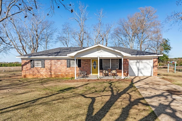 single story home featuring a porch, a garage, and a front lawn